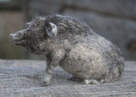needle felted grey pig sitting down